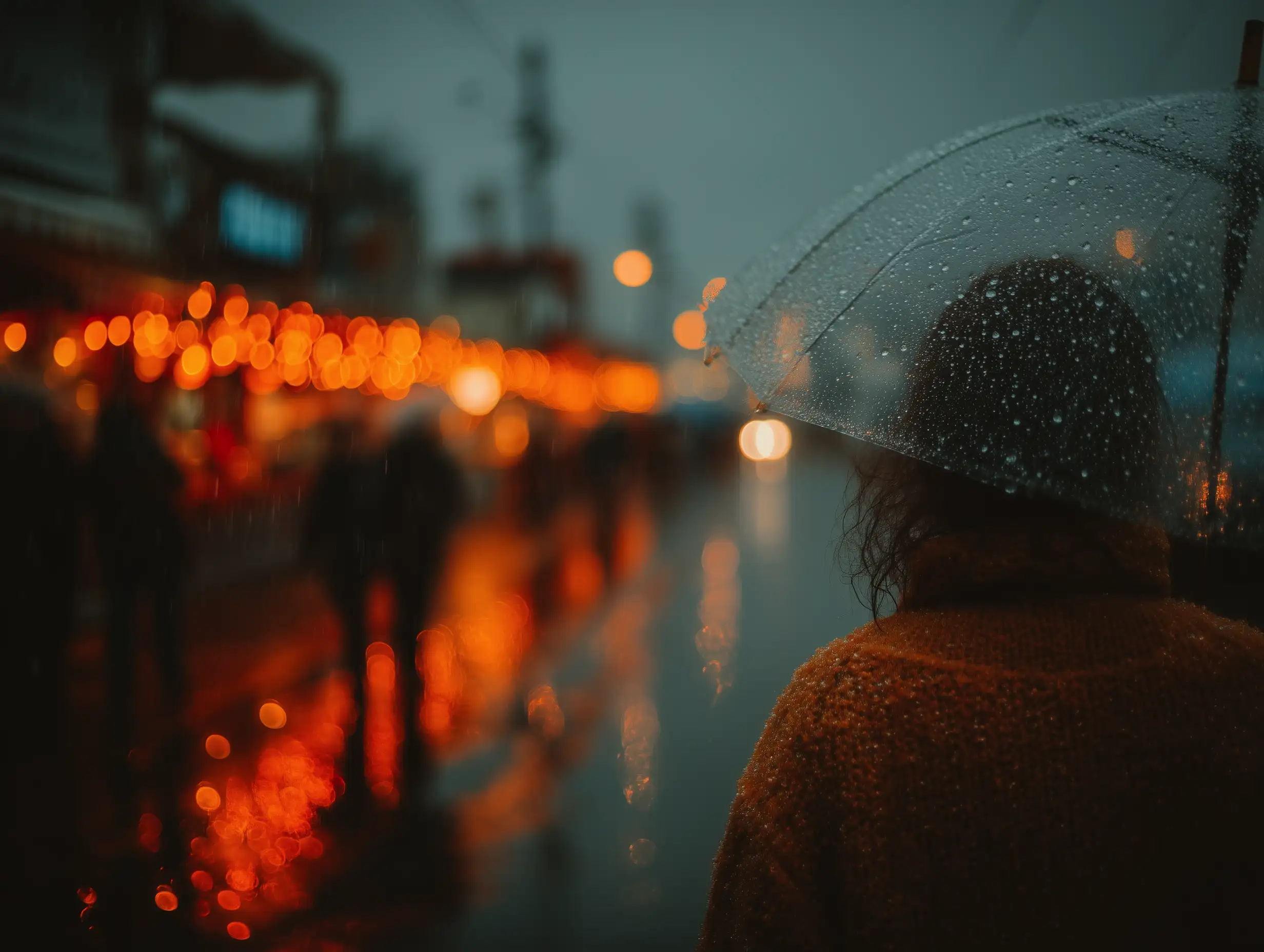 A person holding an umbrella alone under soft rain, backlit by warm streetlights, emotional atmospheric lighting, reflective tone