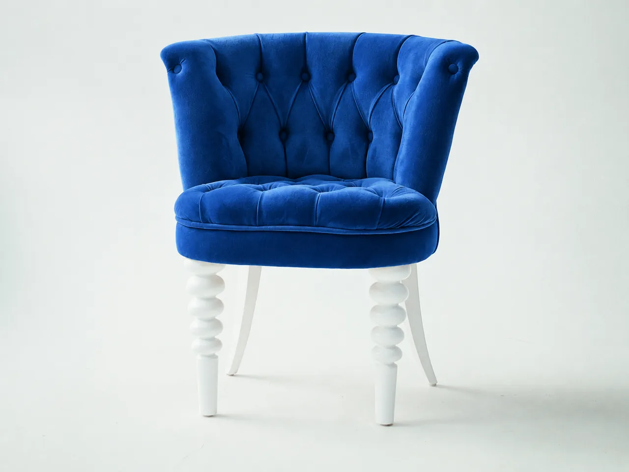 Cobalt-blue velvet chair edit preserving tufted upholstery and white wooden legs