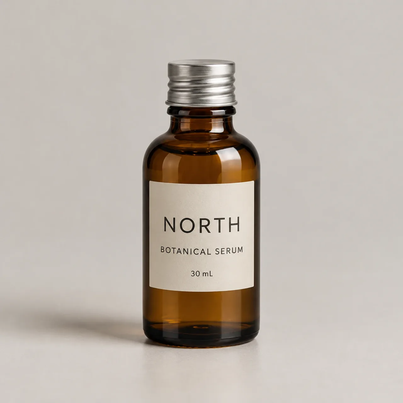Reference · bottle — Amber bottle, silver cap and a cream label reading NORTH / BOTANICAL SERUM / 30 mL.